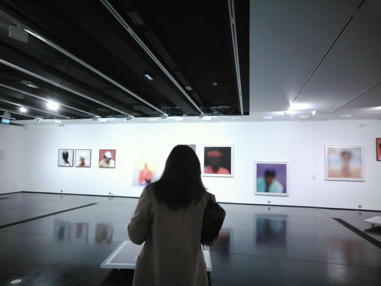 Onlooker at exhibition by Nida KAMAL